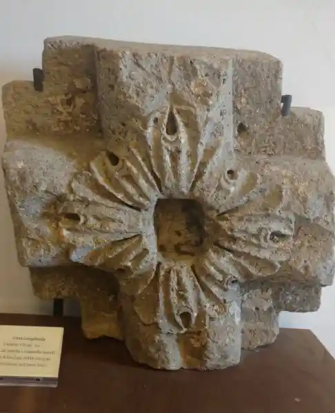 Cross on stone with a solar disc on the center